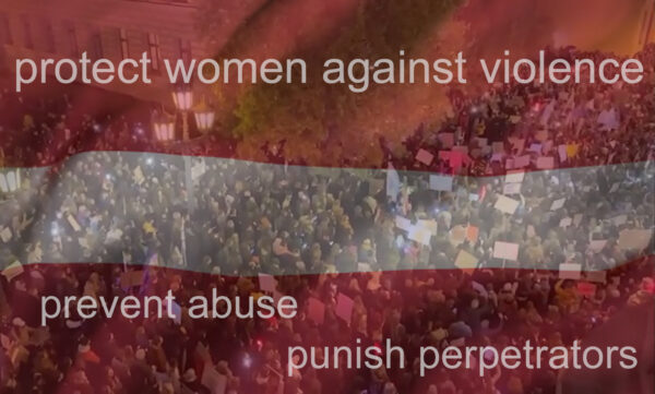 Transparent lettisk flagga över ett folkhav med orden: protect women against violence, prevent abuse, punish perpetrators